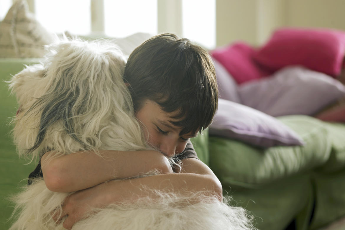 Boy hugging dog